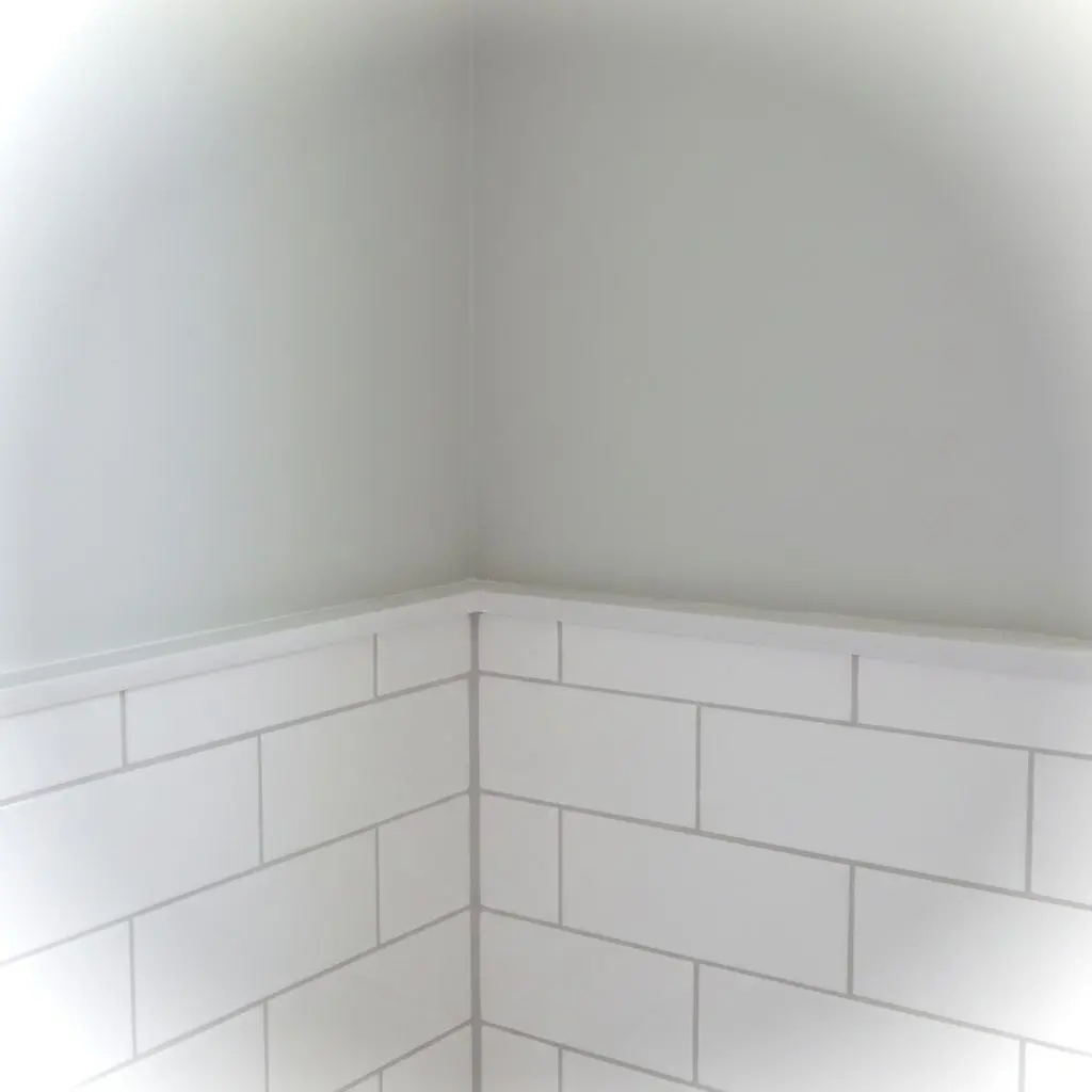 A close, cropped shot of new bathroom tile meeting a fresh vanity edge in a finished remodel, nothing else in frame.